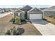 Well-maintained single-story home with green siding, a two-car garage, and neatly landscaped front yard at 775 Oyster Bluff Dr., Myrtle Beach, SC 29588