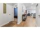 Open hallway showcasing hardwood floors and a glimpse into a blue bedroom, creating a seamless flow at 775 Oyster Bluff Dr., Myrtle Beach, SC 29588