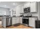 Bright kitchen features granite countertops, stainless steel appliances, and white cabinetry at 775 Oyster Bluff Dr., Myrtle Beach, SC 29588