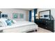 Bright bedroom with a dresser and striped bedding at 8059 Bear Claw Way, Conway, SC 29526