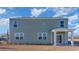 Two-story home with gray siding, covered patio, and manicured lawn at 8059 Bear Claw Way, Conway, SC 29526
