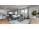Open living room with a teal sofa and ample natural light at 8059 Bear Claw Way, Conway, SC 29526