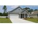 Gray two-story house with white garage door and landscaping at 1110 Barrington Way, Conway, SC 29526