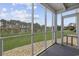 Screened porch with view of yard and trees at 1356 Glenns Bay Rd. # E 204, Surfside Beach, SC 29575