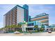 Exterior view of Landmark Resort and signage showing parking, balconies, and ocean views at 1501 S Ocean Blvd. # 811, Myrtle Beach, SC 29577