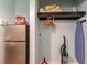 Hallway area features a retro refrigerator, storage area, and cleaning supplies at 1501 S Ocean Blvd. # 811, Myrtle Beach, SC 29577