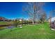 Serene backyard view with lush green grass, mature trees, and a canal, offering a tranquil outdoor setting at 1579 Southwood Dr., Surfside Beach, SC 29575