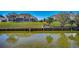Picturesque backyard featuring waterfront views, lush landscaping, and a charming screened porch for outdoor enjoyment at 1579 Southwood Dr., Surfside Beach, SC 29575