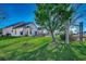 Expansive backyard with mature tree, lush green lawn, swing and canal view, perfect for outdoor recreation at 1579 Southwood Dr., Surfside Beach, SC 29575