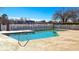 Community pool featuring clear blue water, surrounded by a white fence for safety and privacy for residents at 1579 Southwood Dr., Surfside Beach, SC 29575