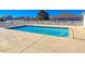 Community pool with clean blue water, surrounded by concrete deck and white fence, perfect for relaxation and recreation at 1579 Southwood Dr., Surfside Beach, SC 29575