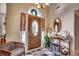 Bright and airy entryway with a wooden door and decorative mirror at 1579 Southwood Dr., Surfside Beach, SC 29575