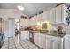 Spacious kitchen with white cabinetry, granite countertops, and modern stainless steel appliances at 1579 Southwood Dr., Surfside Beach, SC 29575