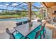 Enjoy alfresco dining with this outdoor table and chairs overlooking the pool at 1968 Vercelli Way, Myrtle Beach, SC 29579