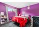 Bedroom with purple walls and large bed at 2000 Green Blvd. # 40B, Myrtle Beach, SC 29577