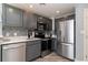 Modern kitchen with stainless steel appliances and gray cabinets at 2501 S Ocean Blvd. # 1219, Myrtle Beach, SC 29577
