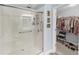 Walk-in shower with grab bars and adjacent closet at 260 S Crow Creek Dr. # 18, Calabash, NC 28467