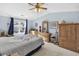 Spacious bedroom with a ceiling fan, large window, and wood furniture at 260 S Crow Creek Dr. # 18, Calabash, NC 28467