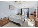 Spacious bedroom with a ceiling fan, large window, and wood furniture at 260 S Crow Creek Dr. # 18, Calabash, NC 28467
