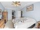 Spacious bedroom with a ceiling fan, large window, and walk-in closet at 260 S Crow Creek Dr. # 18, Calabash, NC 28467