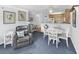 Open dining area with white table and chairs near the kitchen at 260 S Crow Creek Dr. # 18, Calabash, NC 28467