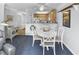 Charming dining area with white table and chairs, adjacent to the kitchen at 260 S Crow Creek Dr. # 18, Calabash, NC 28467