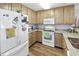 Bright kitchen with wood cabinets, granite countertops, and white appliances at 260 S Crow Creek Dr. # 18, Calabash, NC 28467