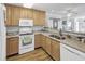 Modern kitchen featuring wood cabinets, granite countertops, and stainless steel appliances at 260 S Crow Creek Dr. # 18, Calabash, NC 28467