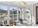 Bright screened porch with potted plants and access to a balcony at 260 S Crow Creek Dr. # 18, Calabash, NC 28467