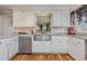 White kitchen cabinets, granite countertops, and a farmhouse sink at 2647 Coats Rd., Loris, SC 29569