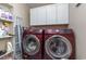 Bright laundry room, washer, dryer, cabinets and shelving at 2647 Coats Rd., Loris, SC 29569