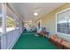 Spacious screened porch, ceiling fans, and green carpet at 2647 Coats Rd., Loris, SC 29569