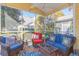 Relaxing screened porch with wicker furniture and colorful rug at 306 River Rock Ln. # 1304, Murrells Inlet, SC 29576