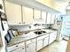 Modern kitchen with granite countertops and white cabinetry at 314 Tall Pines Way # 6-34, Pawleys Island, SC 29585