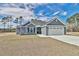 Newly constructed home with gray siding, two-car garage, and landscaped lawn at 340 William Nobles Rd., Aynor, SC 29511
