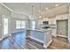 Open kitchen with island, granite counters, stainless steel appliances, and wood floors at 340 William Nobles Rd., Aynor, SC 29511