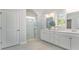 Bathroom featuring a double sink vanity with white cabinets, framed mirror, and a walk-in shower at 378 Glacier Way, Conway, SC 29526