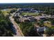 Aerial view of campus and surroundings with roads, trees, and playing fields at 4298 Falls Oaks St., Myrtle Beach, SC 29579