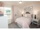 Charming bedroom with pink bedding, neutral decor, and a large window at 4298 Falls Oaks St., Myrtle Beach, SC 29579