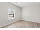 Simple bedroom with light walls, wood floors, and a window at 4300 Crows Nest Ct., Myrtle Beach, SC 29579