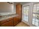 Kitchen features wood cabinets, granite countertops, and a door to the patio at 437 Red Rose Blvd. # 5, Pawleys Island, SC 29585