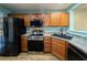 Modern kitchen with stainless steel appliances and wood cabinets at 437 Red Rose Blvd. # 5, Pawleys Island, SC 29585
