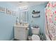 Clean bathroom with white vanity, shower/tub combo, and beachy decor at 501 S Ocean Blvd. # 505, North Myrtle Beach, SC 29582