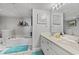 Bathroom with double vanity, large soaking tub, and teal accents at 501 S Ocean Blvd. # 505, North Myrtle Beach, SC 29582