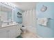 Clean bathroom with white vanity, tub, and shower at 501 S Ocean Blvd. # 505, North Myrtle Beach, SC 29582