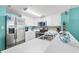 White cabinets, stainless steel appliances, and teal backsplash at 501 S Ocean Blvd. # 505, North Myrtle Beach, SC 29582