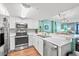 Modern kitchen with stainless steel appliances and light wood floors at 501 S Ocean Blvd. # 505, North Myrtle Beach, SC 29582