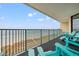 Oceanfront balcony with teal chairs, offering stunning ocean views at 501 S Ocean Blvd. # 505, North Myrtle Beach, SC 29582