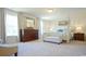 Main bedroom with a large four-poster bed and plenty of natural light at 511 Firouz Dr, Longs, SC 29568