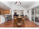 Bright dining area with hardwood floors, a glass-top table and wicker chairs, opens to the kitchen at 535 Belton Dr., Conway, SC 29526